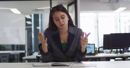 Businesswoman Explaining Information in Modern Office Setting