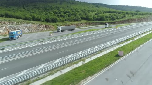 Drone View of Big Cargo Trucks on Highway Pullout in Summer Day