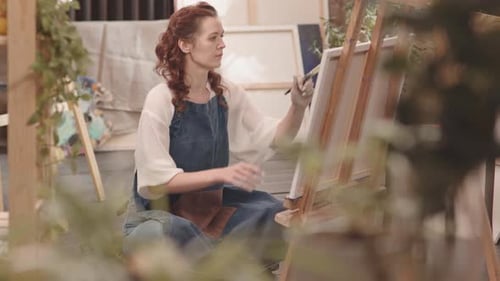 Ginger Woman Painting in Art Studio