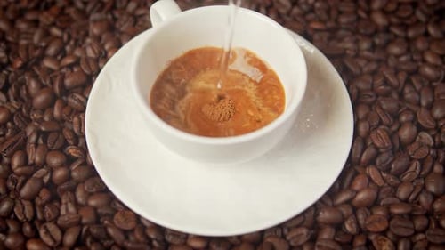 Coffee Cup Filled With Dark Brew Over Beans