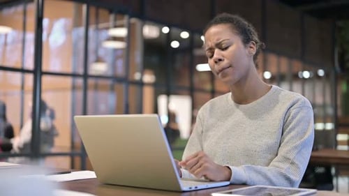 African Woman Shocked By Loss on Laptop