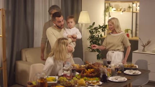 Family Gathering At Dining Table