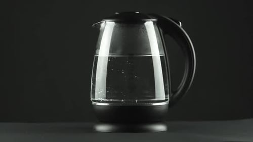 In a Electric Kettle with Transparent Glass Walls, Water Boils. Concept. Studio Shot
