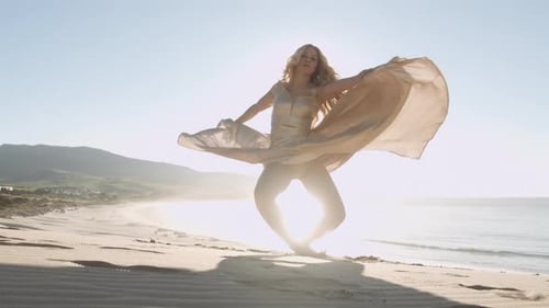 Beautiful Blond Woman In Gold Dress On Sunny Beach