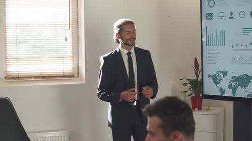 Business Meeting in Office Young Businessman Speak at a Meeting and Shows Financial Infographic in