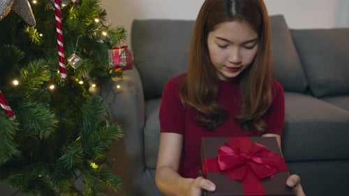 Woman Receives a Christmas Gift with Surprise and Delight