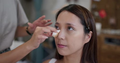 Makeup Artist Applying Makeup to Woman's Face