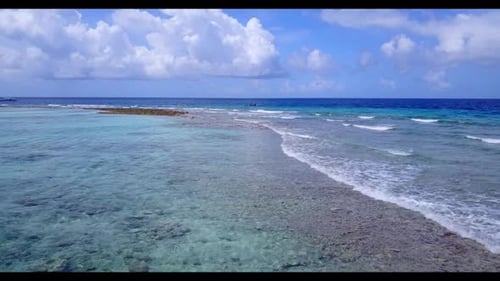 Aerial drone shot seascape of idyllic bay beach holiday by transparent sea with bright sandy backgro