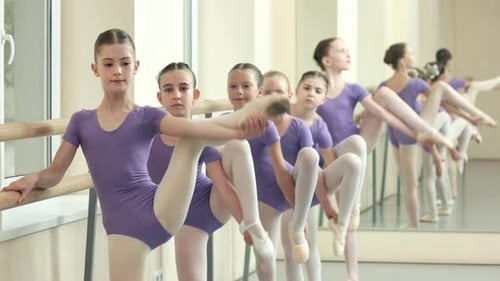Young Ballet Dancers Stretching in Dance Studio