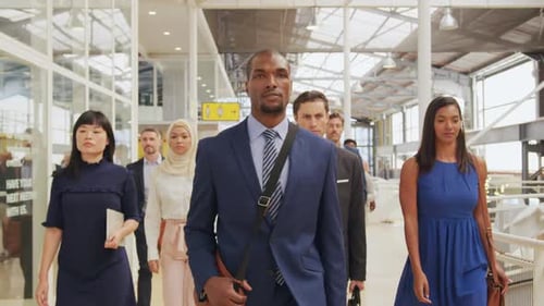 Diverse Team Confidently Walking Through Modern Office