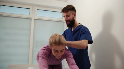 Healthcare Provider Guiding Woman in Torso Stretches