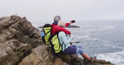 Senior Couple on Coastal Rocks Taking Selfie