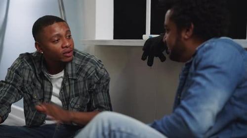 Young Men Chatting Indoors