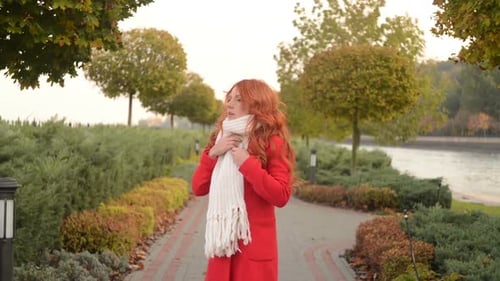 Beautiful Woman in Autumn Park a Cool Windy Day