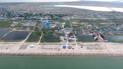 Aerial of Black Sea Shore with Lines of Lounges, Hotels, Houses and Greenery