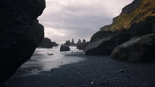 Cliffs and Waves Crashing to the Shore on Black Sand Beach