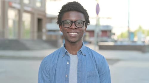 Young Adult Smiling at the Camera in City