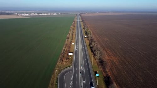 Aerial Drone View Flight Over Highway Between the Fields on Sunny Day