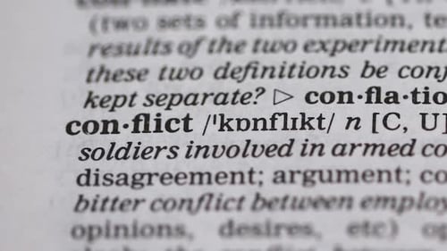 Close Up Of Dictionary Definition Of Conflict