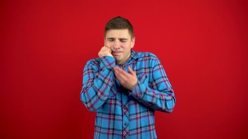 Young Man with Toothache on Red Background
