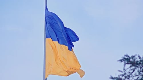 Waving Ukrainian Flag with Blue Sky