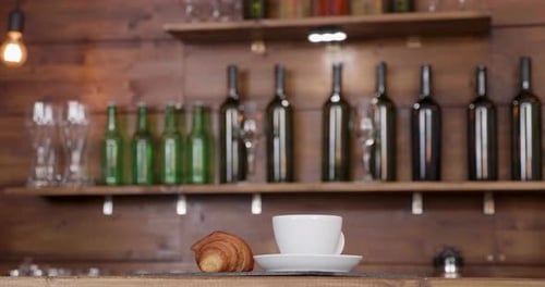 Parallax Shot of a Coffe Cup Placed on a Bar Counter