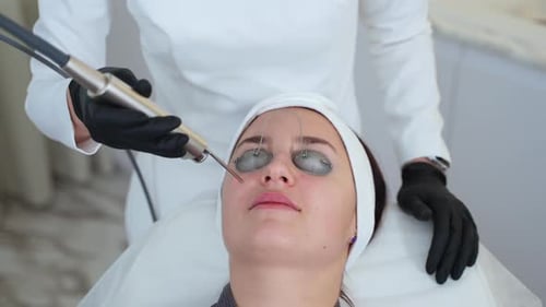 Woman Receiving Facial Laser Treatment at Medical Spa