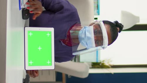 Vertical Video Black Woman Showing to Manager Tablet with Green Screen