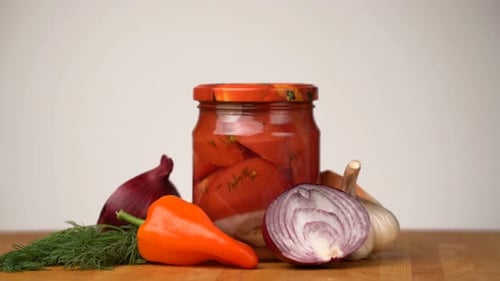 Canned Tomatoes and Vegetables on Wooden Table