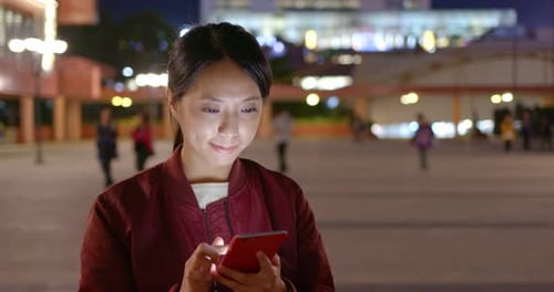 Woman use of mobile phone at night