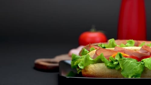 Tasty sandwiches on a black background close up