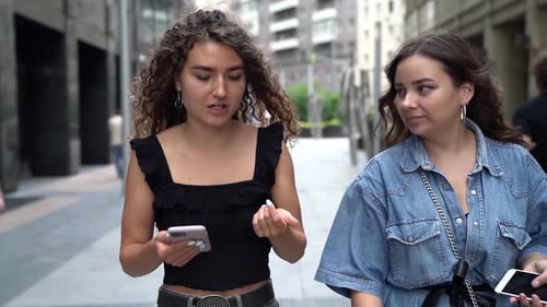 Two Groupmates Students Women Are Walking Together on City Street and Gossiping Cheerfully