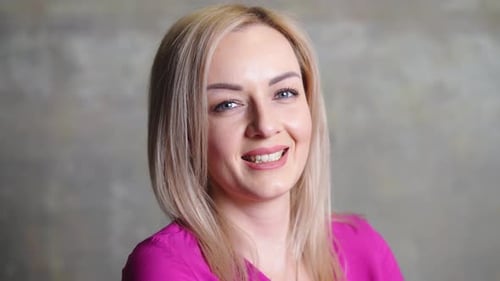 Caucasian Woman with Blond Hair in Pink Shirt Close Up Portrait
