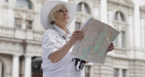 Woman Examining Map on Trip
