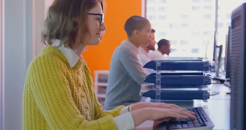 Side view of Young mixed race business team working together at desk in modern office 4k