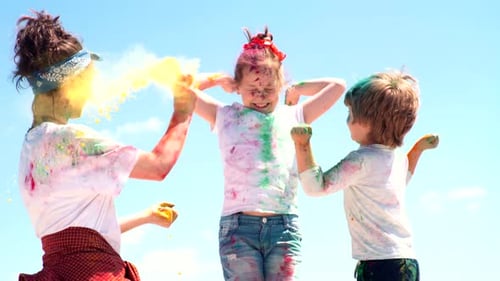 Friends Celebrate Holi With Colorful Powder Outdoors