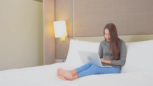 Young Woman Celebrates Success While Using Laptop