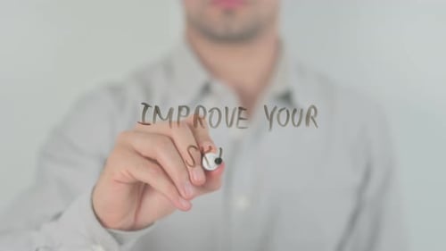 Man Writes "Improve Your Skills" with Marker