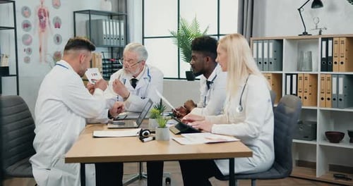 Medical Team Discussing Charts and Graphs