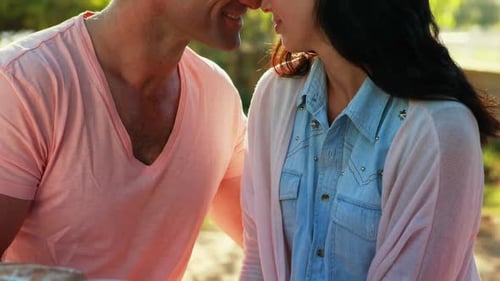 Loving Couple Touching Foreheads in Sunny Outdoors