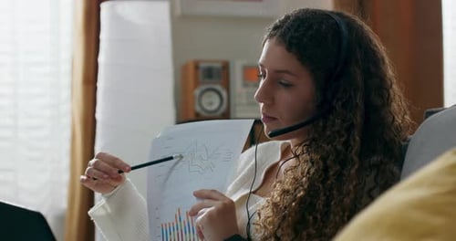 A Responsible Hardworking Smiling Woman is Looking Through Company Documents Leafing Through Each