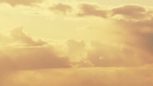 Sun Rays Shining Through Cloudy Rainy Sky With Fluffy Rain Clouds