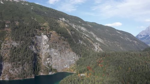 Majestic Drone Shot of Forest and Snowcapped Mountain Landscape