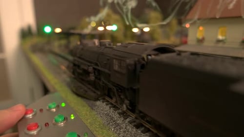 Model Steam Locomotive Passing Through Station.