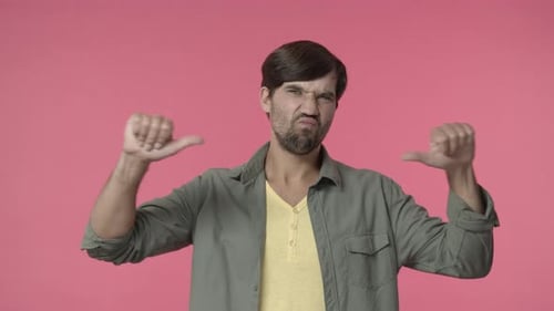 Young Adult Expressing Dislike with Thumbs Down