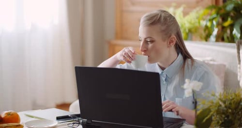Smiling Woman Working on Laptop at Home Office. Businesswoman Typing on Computer Keyboard.