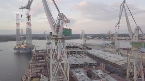 Aerial View of Shipbuilding Yard with Towering Cranes
