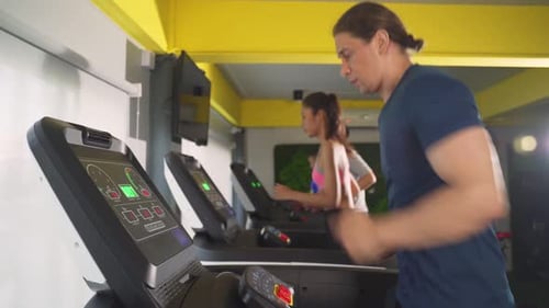 People Running on Treadmills at the Gym