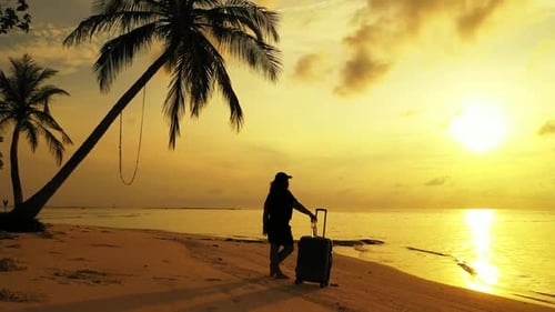 Woman relaxing on paradise resort beach trip by blue sea and white sandy background of the Maldives