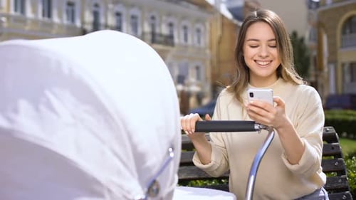 Irresponsible Female Chatting on Smartphone Ignoring Crying Baby in Stroller